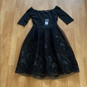 Black, knee length cocktail dress.